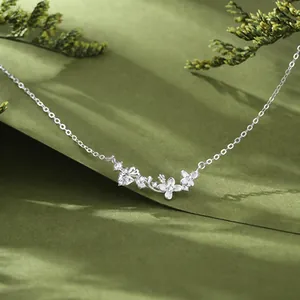 Close-up detail of silver laurel goddess necklace with sparkling moissanite floral pendant