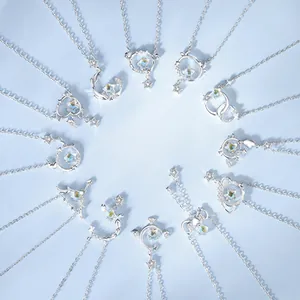 Set of 12 constellation necklaces with moissanite stones on a light blue background