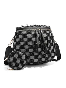 Detailed view of frayed checkerboard crossbody bag with round coin purse