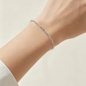 Detailed macro view of a minimalist S925 sterling silver paperclip chain bracelet