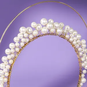 Elegant French forest-style pearl headband with gold wire wrapping on purple background