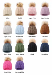 Showcase of various color options for children's knitted beanies with fur pom-poms