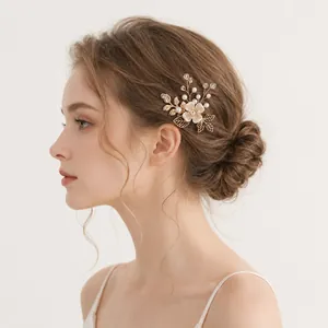 Side view of a model wearing a handmade floral hair pin with pearls and gold leaves.