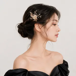 Elegant handmade floral U-shaped hairpin with gold leaves and pearls for bridal hairstyles.
