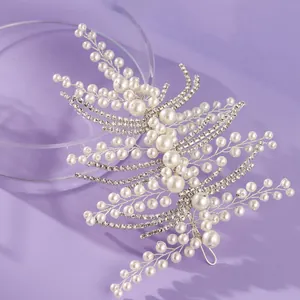 Elegant bridal hair vine decorated with faux pearls and rhinestones on lavender background