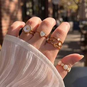 Elegant gold stainless steel rings set with celestial star, moon, and heart shell motifs.