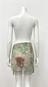 Back view of floral printed mini skirt with sequins and beaded fringe details