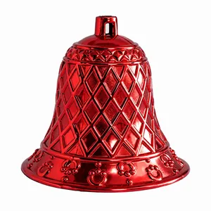 Detailed view of a bright red metallic plastic Christmas bell featuring a textured grid pattern