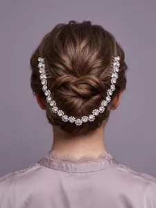 Detail view of a luxurious rhinestone bridal hair comb in an elegant bun hairstyle.