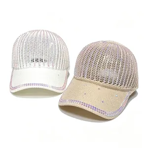 Detailed view of two elegant rhinestone mesh baseball caps in white and beige tones