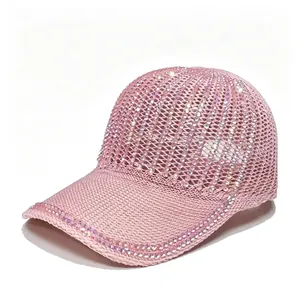 Close-up detail of a pink mesh baseball cap embellished with sparkling rhinestones.