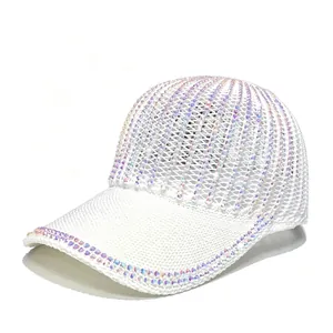 Close-up of white mesh baseball cap featuring iridescent rhinestone decorations on the brim.