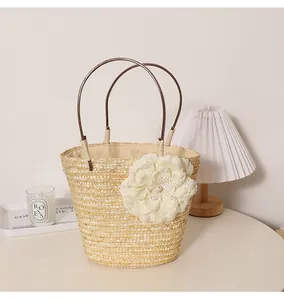 Vue détaillée du sac de plage en paille avec grande fleur et anses rondes