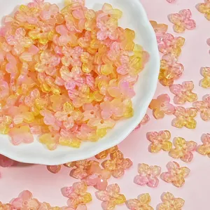 Close-up of 10mm translucent pink and yellow glass flower beads for DIY jewelry making
