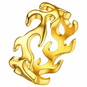 Detail view of golden flame-shaped stainless steel hip-hop ring with polished finish