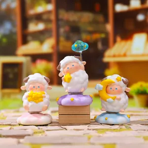 Detailed view of three celestial themed rotating sheep figurines for desktop decoration