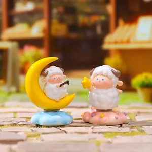 Macro view of cute sheep figurines sitting on moon and star bases with cloud detail
