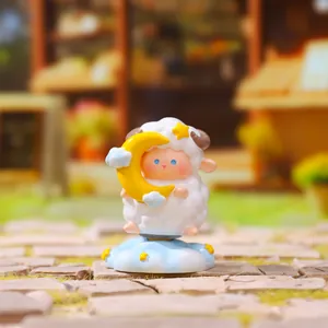 Close-up of a creative sheep blind box figurine holding a crescent moon on a blue cloud base.