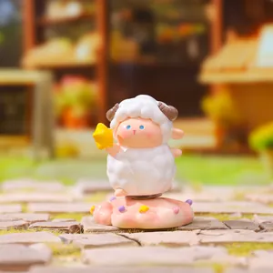 Close-up of cute white sheep figurine holding a yellow star from Mee Mee Lam collection