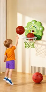 Young child playing with a cartoon dinosaur wall-mounted basketball hoop set indoors.