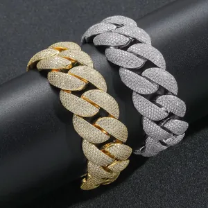 Detailed macro shot of 22mm iced-out Cuban link necklaces in gold and silver finishes