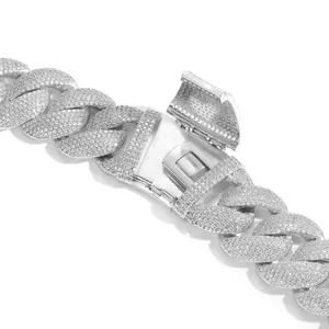 Detailed macro view of a 22mm silver-tone iced out Cuban link chain necklace clasp