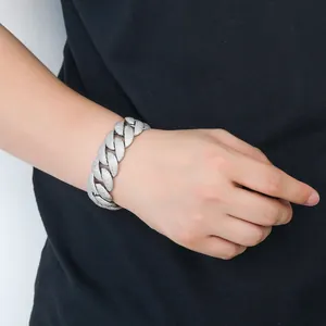 Detail view of a premium 22mm iced out silver Cuban link bracelet on a male wrist