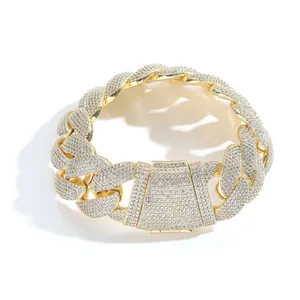 Close-up of a 22mm wide gold Cuban link necklace heavily iced with clear stones