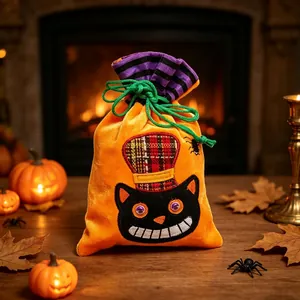 Close-up of Halloween orange velvet drawstring bag with black cat and plaid hat design