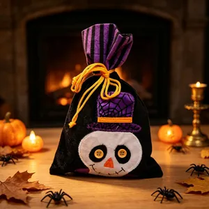 Close-up of a festive Halloween skull drawstring candy bag in a cozy fireplace setting.