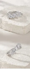 Macro detail view of an S925 sterling silver cross ring set with sparkling moissanite stones.