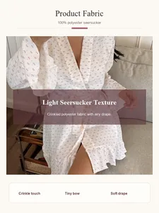 Close-up of white floral seersucker bathrobe showing crinkled texture and soft drape