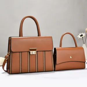 Elegant set of two brown leather handbags featuring textured stripes and gold-tone clasps