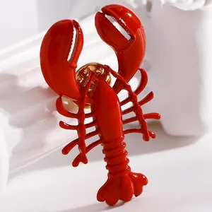 Close-up of a vibrant red enamel lobster brooch featuring a detailed glossy finish