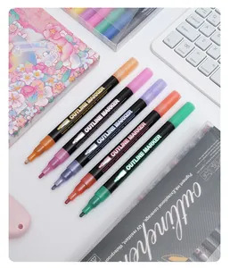 Close-up of five vibrant double-line outline markers for DIY scrapbooking and holiday cards