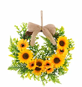 Detailed view of artificial sunflower wreath with vibrant greenery and burlap bow