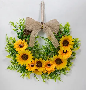 Front detailed view of a decorative sunflower wreath featuring a rustic burlap bow