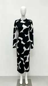 Detailed view of a slim-fit high-neck knitted long-sleeve dress with abstract black and white pattern