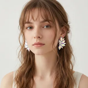 Close-up of elegant iridescent marquise diamond leaf-shaped stud earrings on model