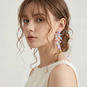 Close-up of colorful marquise crystal floral earrings worn by a model for gala events.