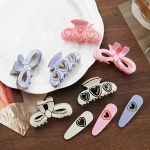 Elegant collection of bow-shaped and heart-patterned hair claw clips in pastel colors