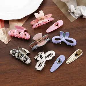 Assorted stylish bow and heart design hair claw clips in elegant pastel colors for women