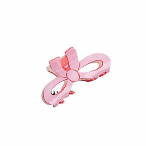 Pink bow hair claw clip with glossy finish for elegant hairstyle, 2024 fashion accessory.