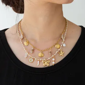 Close-up of double-layer stainless steel necklace with seashell and starfish charms.