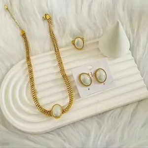 Gros plan d'un ensemble de bijoux dorés vintage avec de grandes perles blanches