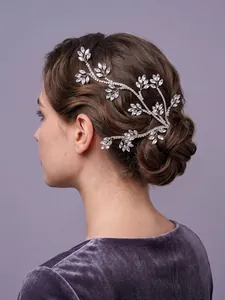 Close-up detail of silver crystal vine bridal hair accessory on elegant bun hairstyle
