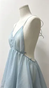 Side view detail of a sexy light blue deep V-neck backless pleated mini dress for women.