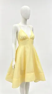 Close-up detail of an elegant yellow V-neck spaghetti strap pleated puffy dress