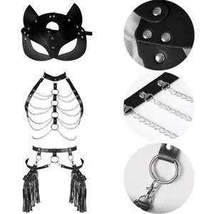 Close-up detail view of black leather fox mask and harness set with metal chains