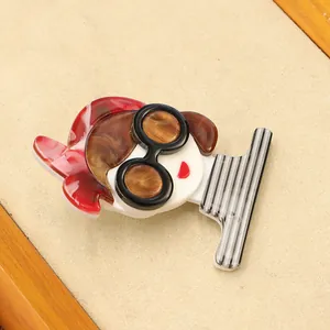 Close-up of stylish acrylic girl brooch with red headscarf and striped pattern